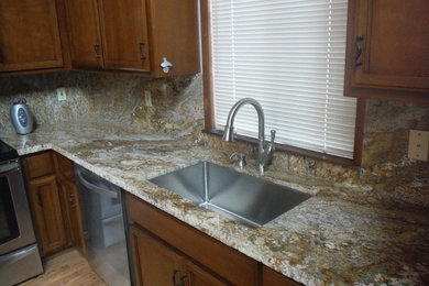 Example of a mountain style kitchen design in Sacramento with an undermount sink, granite countertops and stone slab backsplash