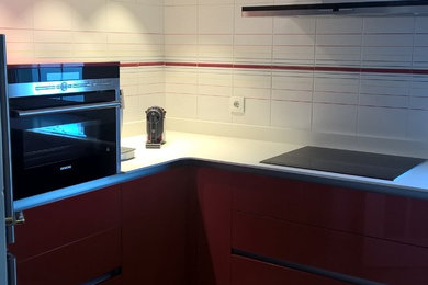 Photo of a small contemporary u-shaped separate kitchen in Other with an undermount sink, recessed-panel cabinets, red cabinets, quartz benchtops, white splashback, ceramic splashback, stainless steel appliances, ceramic floors and no island.