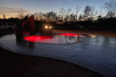 Inspiration for a mid-sized timeless backyard stamped concrete and kidney-shaped lap pool remodel in DC Metro