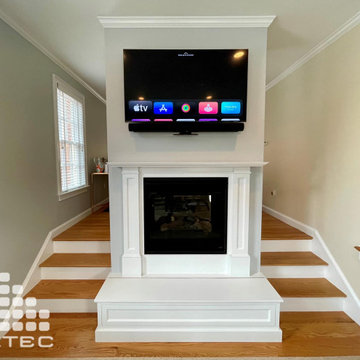 Pull-Down TV mounted over fireplace