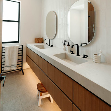 Double vanity with pill-shaped mirrors and toe-kick lighting - Woodland Hills
