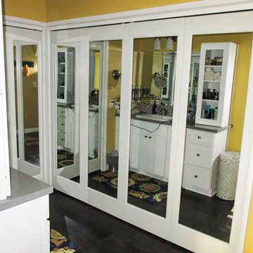 Bi-Folding Mirror Ovation Closet Doors in a Bathroom