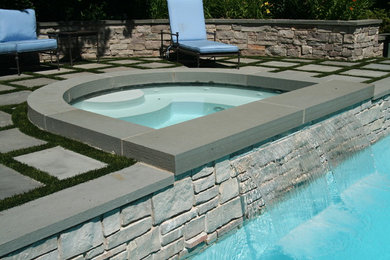 Nassau pool with raised spa, auto cover and water feature.