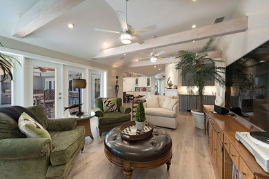 Design ideas for an expansive open concept family room in Miami with light hardwood floors.