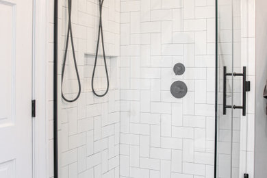 Example of a large 1960s master white tile and ceramic tile porcelain tile, black floor and double-sink bathroom design in Milwaukee with shaker cabinets, white cabinets, a two-piece toilet, gray walls, an undermount sink, quartz countertops, a hinged shower door, white countertops, a niche and a built-in vanity