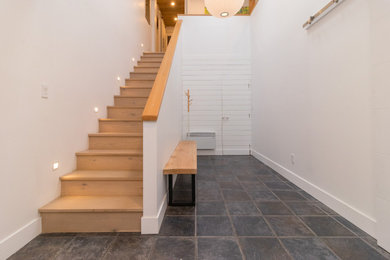 Inspiration for a rustic wooden wood railing staircase remodel in Other with wooden risers