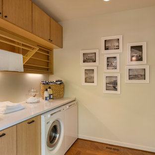 Medium sized retro galley utility room in Portland with flat-panel cabinets, medium wood cabinets, engineered stone countertops and a side by side washer and dryer.