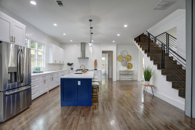 Large transitional galley eat-in kitchen in Atlanta with an undermount sink, shaker cabinets, blue cabinets, quartzite benchtops, white splashback, ceramic splashback, stainless steel appliances, dark hardwood floors, with island, grey floor and white benchtop.