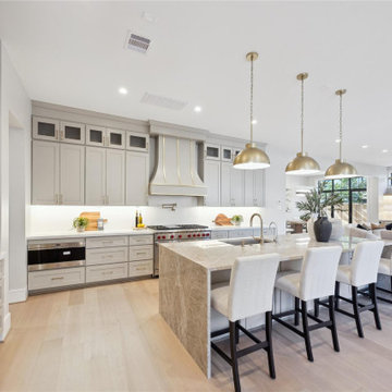 Custom range hood and gray perimeter cabinetry, West University