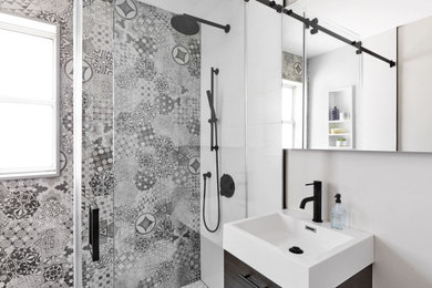 Bathroom - small modern kids' gray tile and cement tile porcelain tile, white floor and single-sink bathroom idea in Toronto with flat-panel cabinets, dark wood cabinets, a two-piece toilet, white walls, an integrated sink, solid surface countertops, white countertops, a niche and a floating vanity