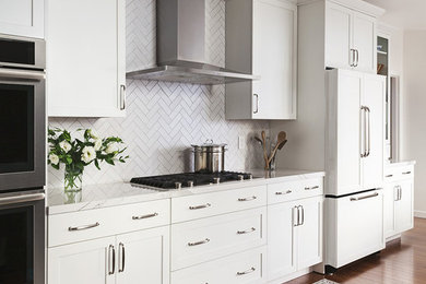 Example of a transitional u-shaped dark wood floor kitchen design in San Francisco with shaker cabinets, white cabinets, white backsplash, stainless steel appliances, marble countertops and porcelain backsplash