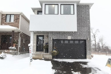 Modern gray two-story mixed siding exterior home idea in Toronto