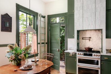 Kitchen - mid-sized french country l-shaped kitchen idea in Other with an undermount sink, green cabinets, marble countertops, marble backsplash and an island