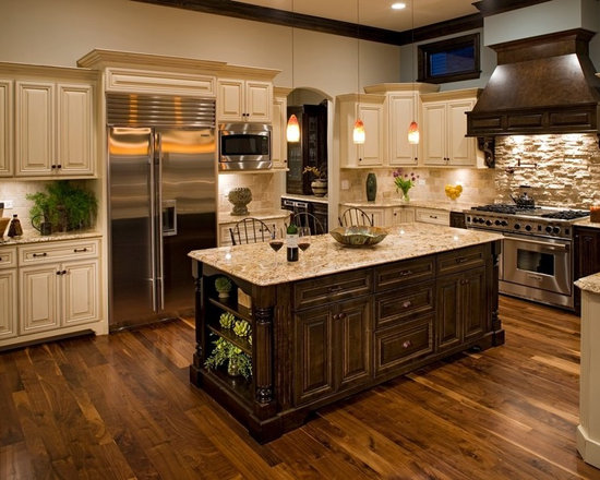 Mid-sized traditional enclosed kitchen pictures - Inspiration for a mid-sized timeless u-shaped dark wood floor enclosed kitchen remodel in Chicago with raised-panel cabinets, beige cabinets, beige backsplash, stone tile backsplash, stainless steel appliances, granite countertops, an island and a double-bowl sink