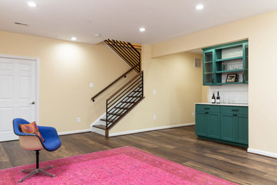 Inspiration for a contemporary dark wood floor and brown floor basement remodel in DC Metro with yellow walls