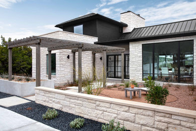 Two-story mixed siding house exterior idea in Austin with a metal roof and a black roof