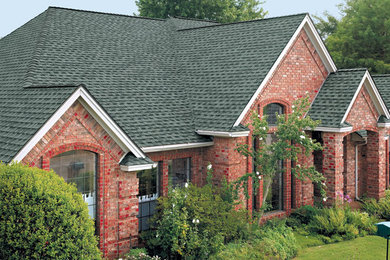 Example of a large classic red two-story brick exterior home design in Tampa with a hip roof