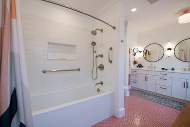Example of a mid-sized eclectic master ceramic tile, red floor and double-sink bathroom design in Bridgeport with white cabinets, a two-piece toilet, an undermount sink, solid surface countertops, white countertops, a niche and a built-in vanity