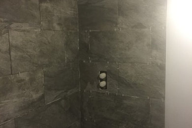 Design ideas for a contemporary bathroom with a corner bath, a shower/bath combination, grey tiles, grey walls, porcelain flooring and ceramic tiles.