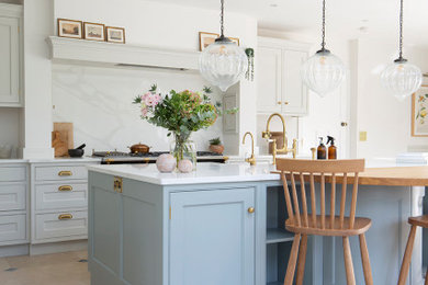 This is an example of a kitchen in Other with limestone flooring and an island.
