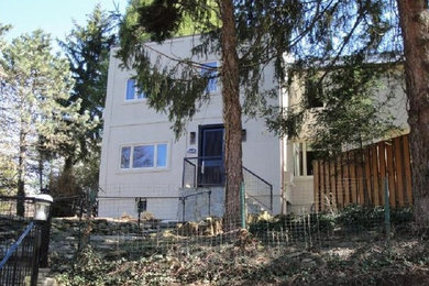 Example of a large minimalist beige two-story stucco exterior home design in DC Metro with a tile roof