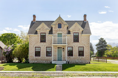 Example of a cottage beige two-story brick house exterior design in Salt Lake City