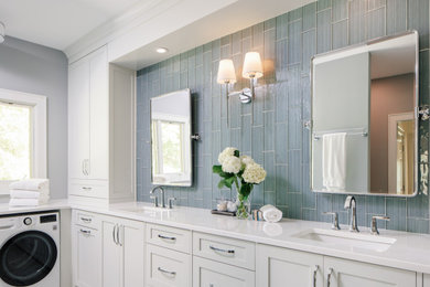 Example of a mid-sized transitional master blue tile and glass tile porcelain tile, white floor and double-sink bathroom design in Atlanta with shaker cabinets, white cabinets, a one-piece toilet, blue walls, an undermount sink, quartz countertops, a hinged shower door, white countertops and a built-in vanity