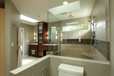 This is an example of a mid-sized contemporary master bathroom in Portland with flat-panel cabinets, dark wood cabinets, a curbless shower, a two-piece toilet, beige tile, porcelain tile, beige walls, porcelain floors, an undermount sink, quartzite benchtops, beige floor and a hinged shower door.