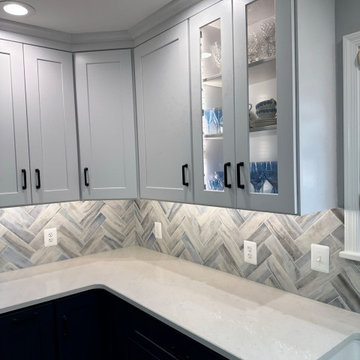 White upper cabinets with black handles