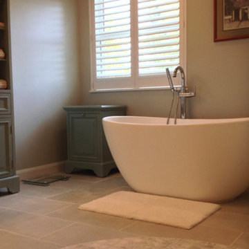Freestanding resin bathtub in an open shower