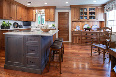 Photo of a mid-sized country l-shaped separate kitchen in Charlotte with beaded inset cabinets, medium wood cabinets, quartzite benchtops, medium hardwood floors, with island and white benchtop.