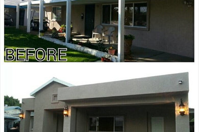 Example of a large classic front yard concrete patio design in Los Angeles with a roof extension