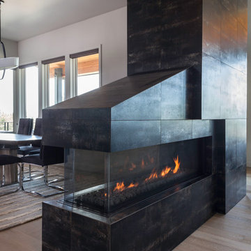Contemporary Fireplace separating living and dining