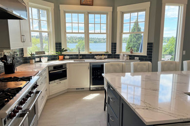 Inspiration for a mid-sized transitional l-shaped open concept kitchen remodel in Seattle with shaker cabinets, white cabinets, quartz countertops, an island and white countertops