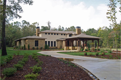This is an example of a transitional two-storey stucco exterior in Other with a hip roof.