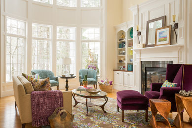 Large elegant formal light wood floor living room photo in Boston with yellow walls, a standard fireplace and a metal fireplace