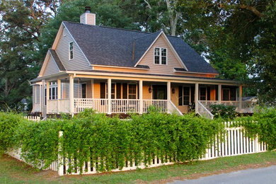 Inspiration for a mid-sized cottage beige two-story wood exterior home remodel in Raleigh