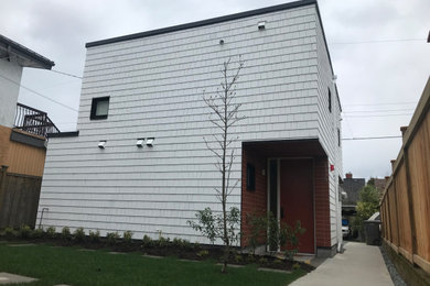 Example of a small two-story wood and shingle tiny house design in Vancouver