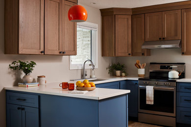 Example of a transitional kitchen design in Minneapolis with white countertops and shaker cabinets