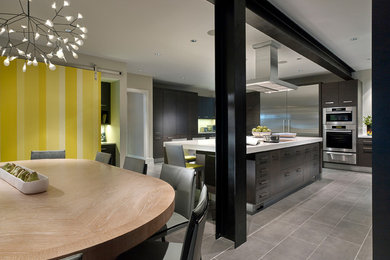 Kitchen - modern porcelain tile kitchen idea in Philadelphia with a farmhouse sink, flat-panel cabinets, dark wood cabinets, quartz countertops, white backsplash, stone slab backsplash, stainless steel appliances and an island