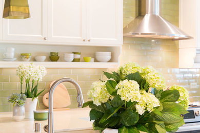 Kitchen - medium tone wood floor kitchen idea in Other with an undermount sink, recessed-panel cabinets, white cabinets, quartz countertops, green backsplash, subway tile backsplash, stainless steel appliances and a peninsula