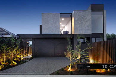 Large contemporary two-storey concrete grey house exterior in Melbourne with a flat roof.