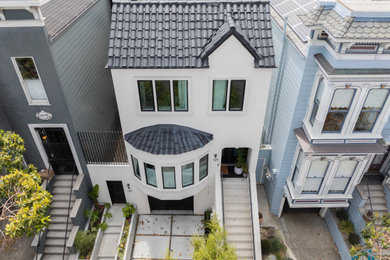 Example of a small minimalist two-story exterior home design in San Francisco with a black roof
