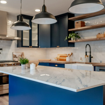 Industrial Matte Black Pendant Lighting over Navy Kitchen Island