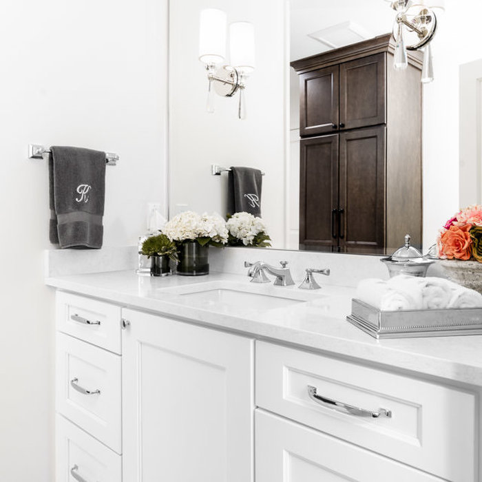 This guest bathroom vanity and entrance doubles as the main powder room for the home. Stalburg Design created a visual separation for this space from the rest of the bathroom, with a large custom wood