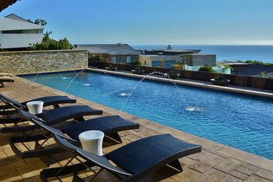 Pool fountain - mediterranean backyard rectangular pool fountain idea in Los Angeles