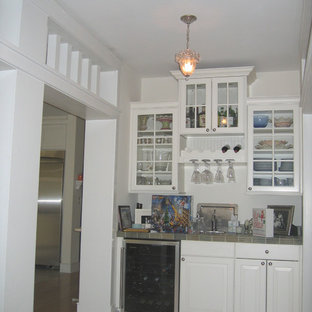 フィラデルフィアの小さいトラディショナルスタイルのおしゃれなウェットバー (ドロップインシンク、ガラス扉のキャビネット、白いキャビネット、タイルカウンター、淡色無垢フローリング) の写真