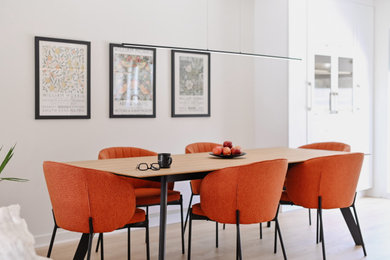 Mid-sized danish light wood floor and beige floor kitchen/dining room combo photo in Montreal with white walls