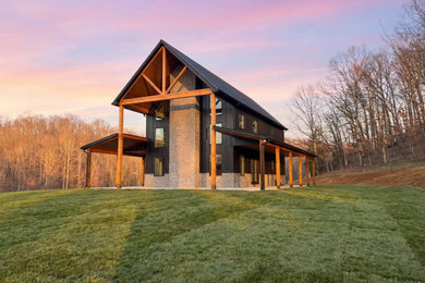 Large country concrete porch idea in Nashville with a roof extension