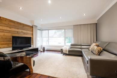 Mid-sized urban loft-style light wood floor family room photo in Montreal with gray walls and a tv stand